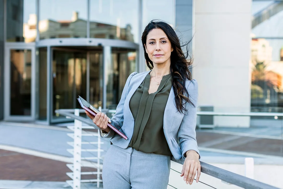 Businesswoman with a notebook outside a Barclays office, Cape Town