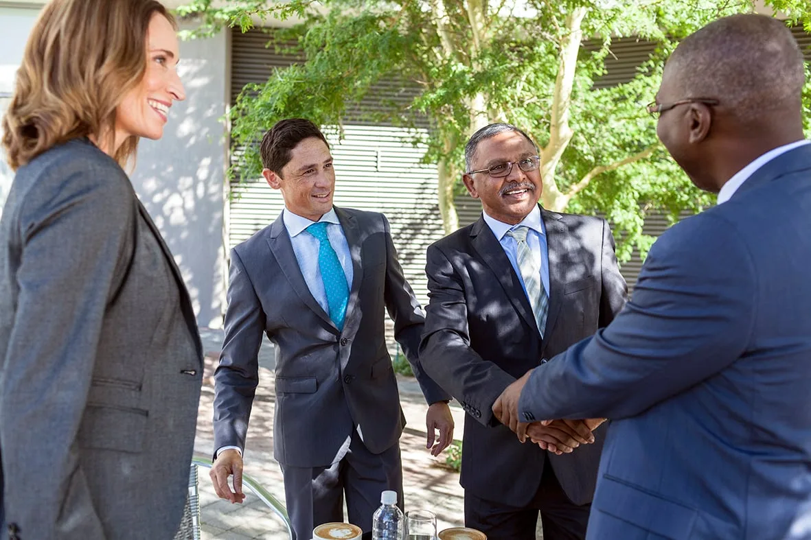 Executives meeting over coffee outdoors, Barclays Cape Town