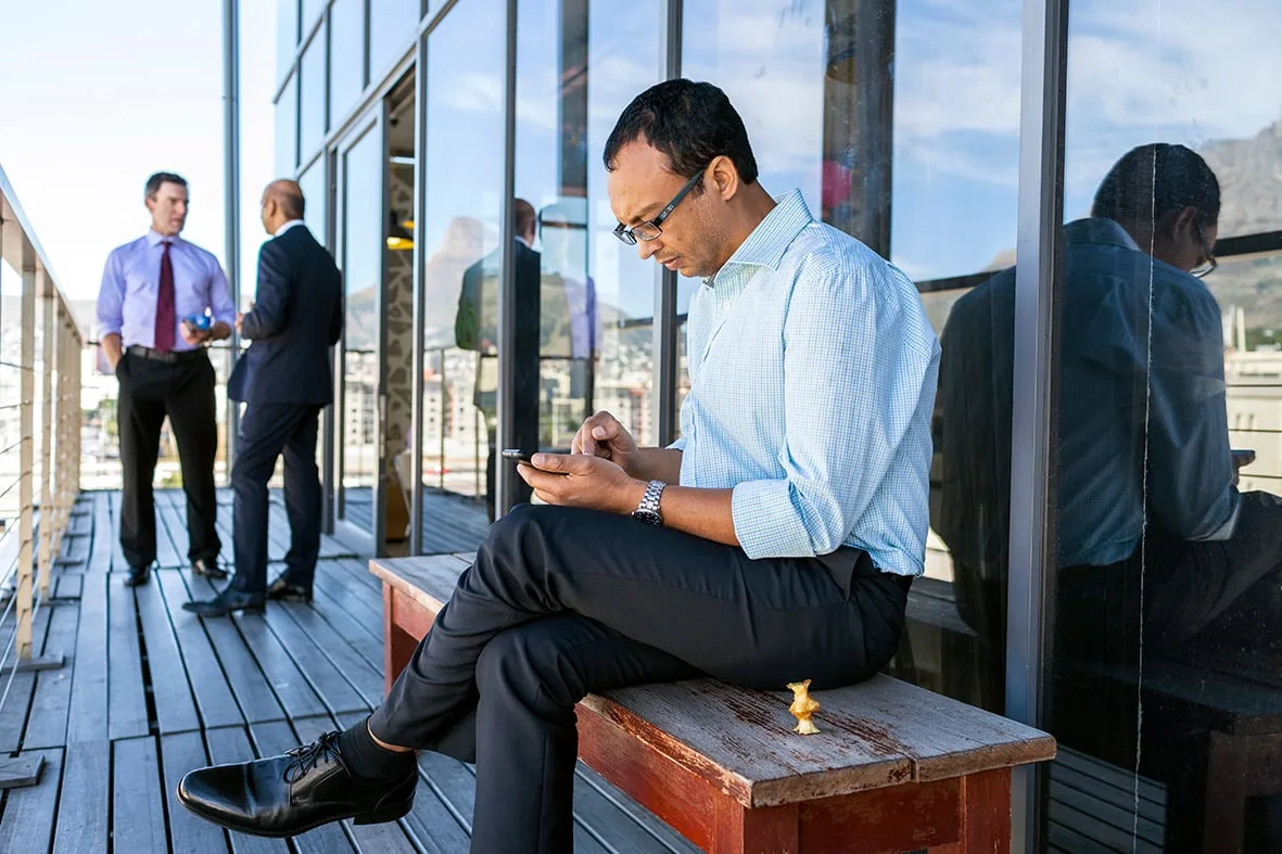 Businessman on a terrace with Table Mountain behind, Barclays Cape Town