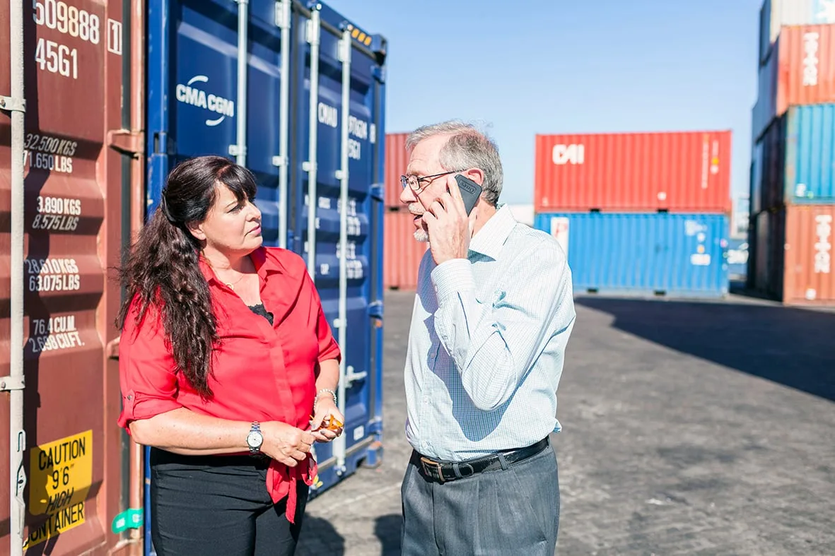Two colleagues talking in a shipping-container yard, Barclays Cape Town