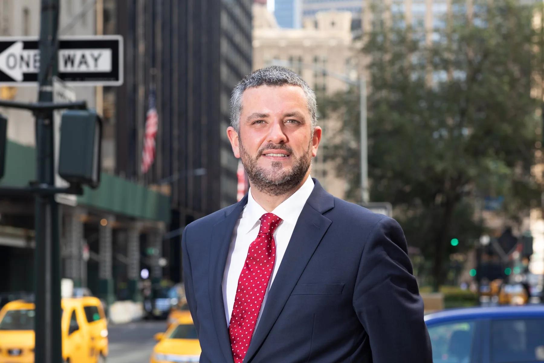 Businessman portrait on a Manhattan street with yellow cabs, New York