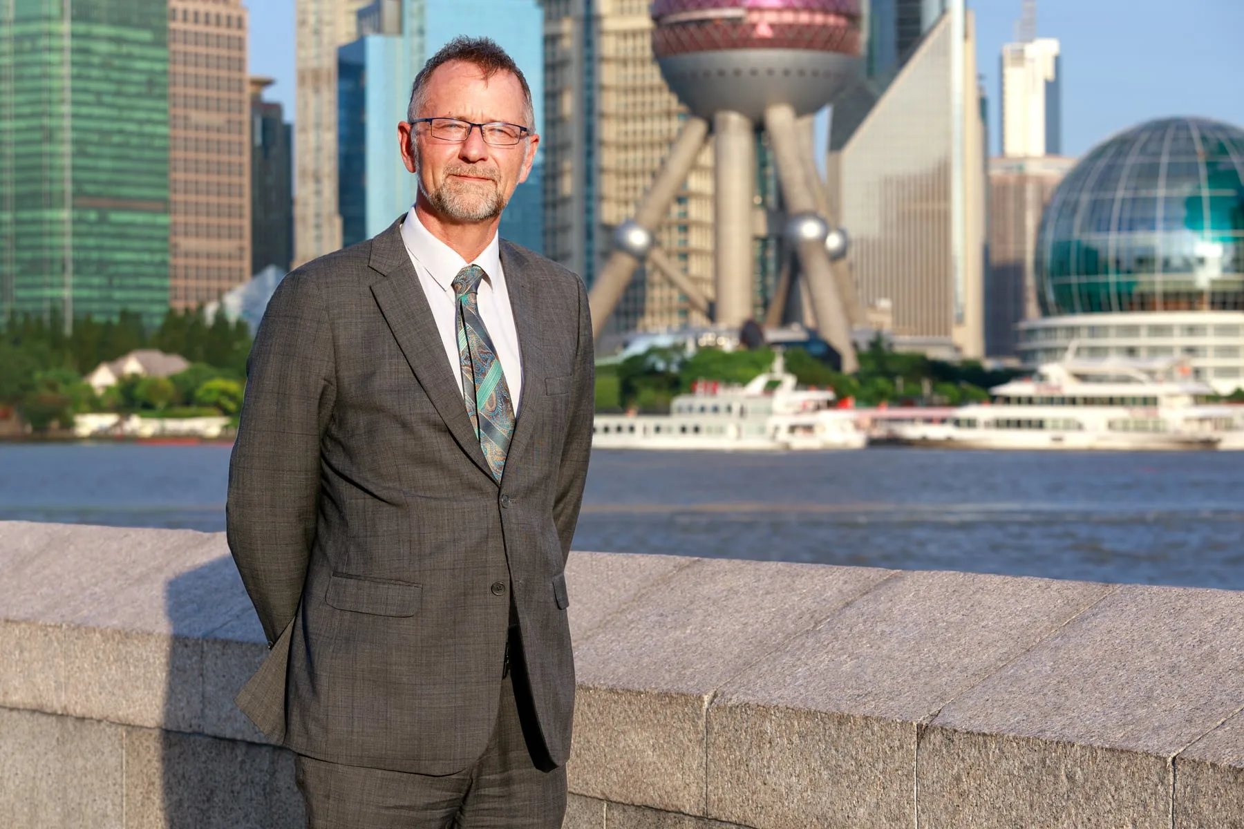 Corporate portrait on the Bund, Oriental Pearl Tower behind, Shanghai
