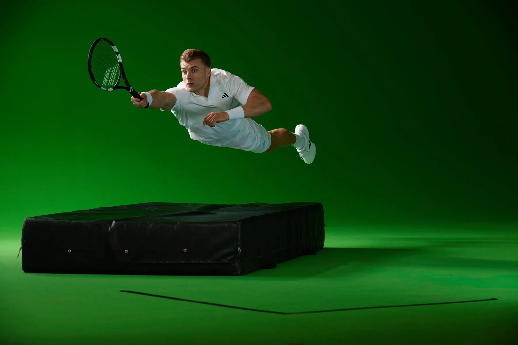 Green-screen studio capture of a diving tennis player, Emirates campaign