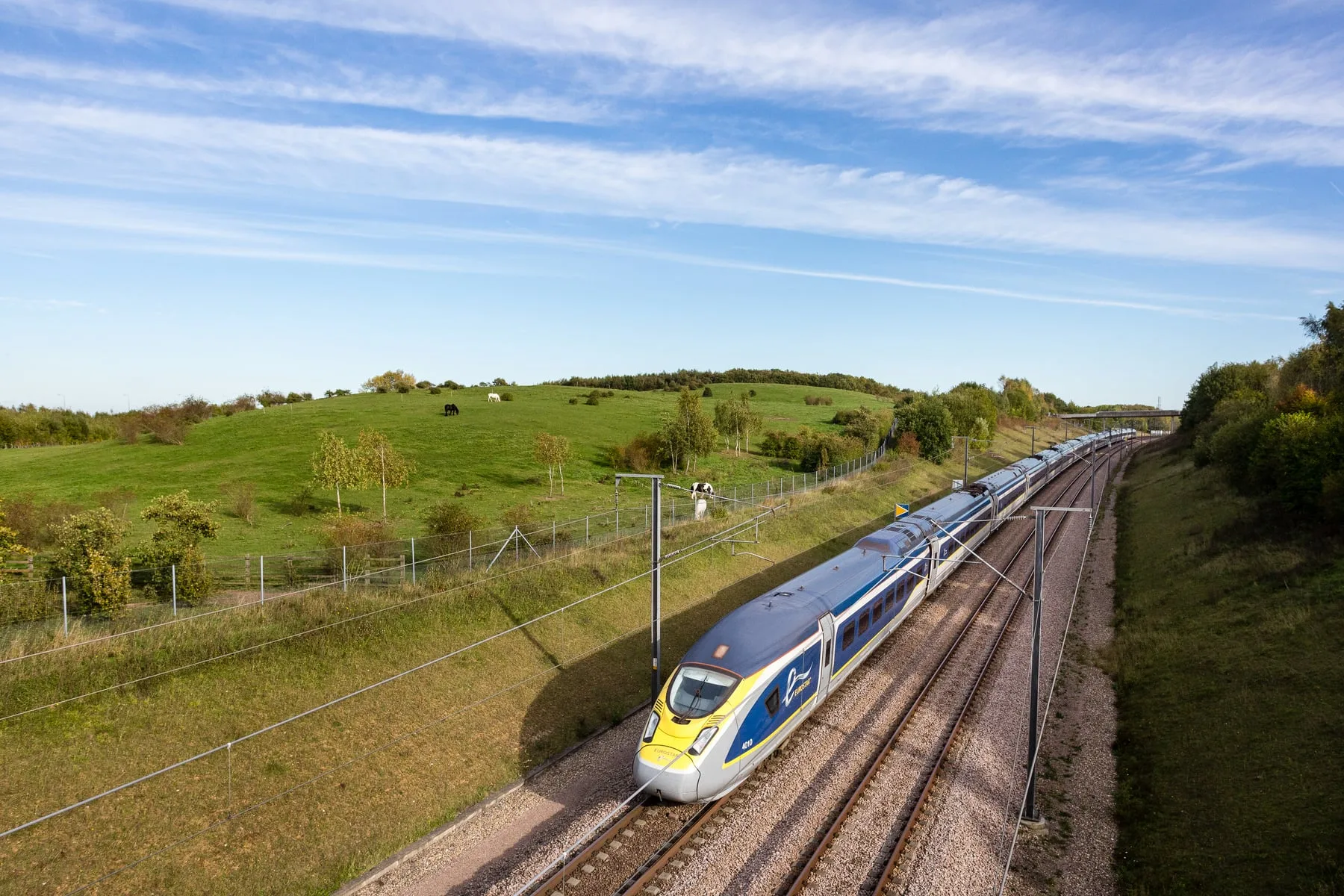 Eurostar e320 rounding a curve through autumn countryside