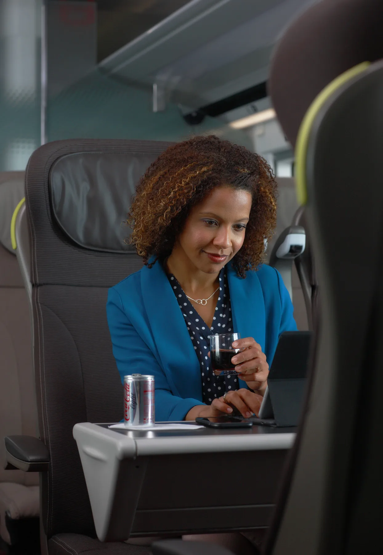 Businesswoman working on a tablet aboard a Eurostar train