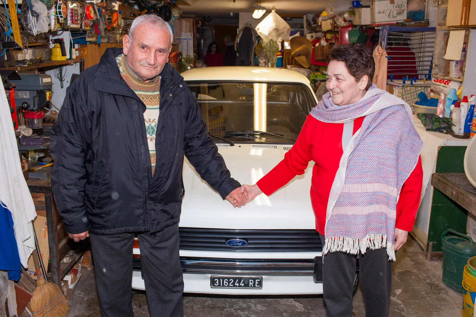 Paolo and his wife hold hands across the bonnet of their white Ford in a Reggio Emilia garage — Ford 'Keep It Real'