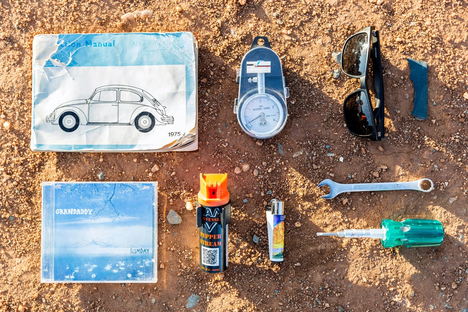 Ilan Godfrey's Beetle glovebox laid out in the Johannesburg dust — GoCompare 'Inside the Glovebox'
