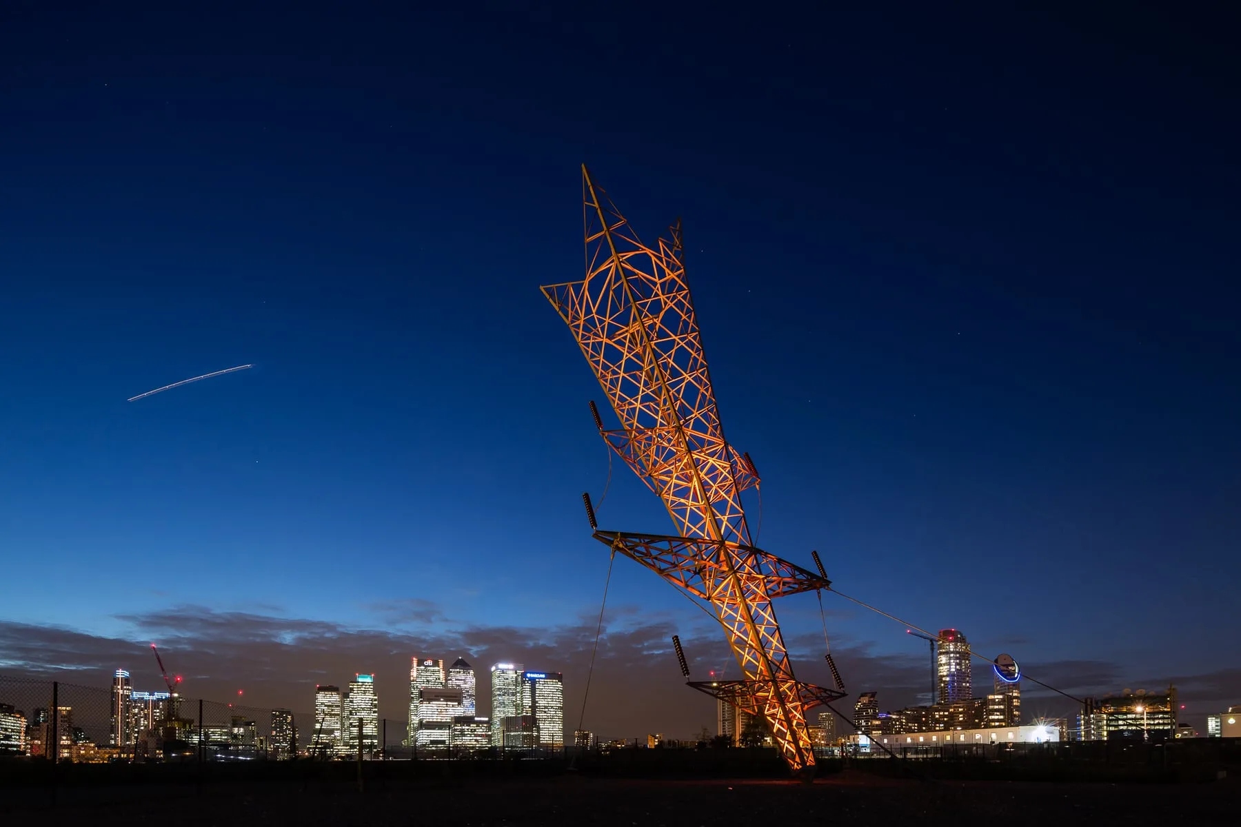 'A Bullet from a Shooting Star' at dusk over the Canary Wharf skyline, London — OSRAM