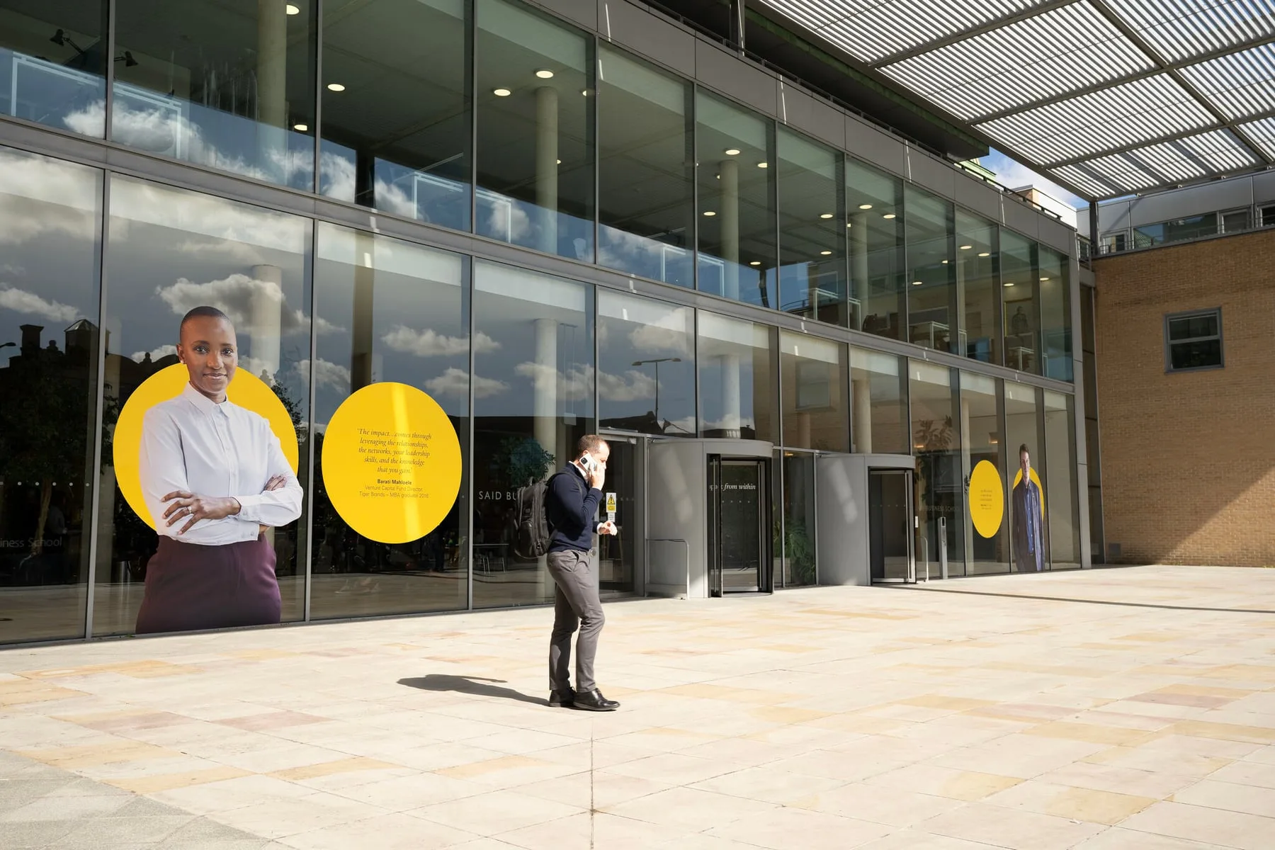 The campaign as window graphics across the Saïd Business School façade in Oxford, Barati Mahloele of Tiger Brands