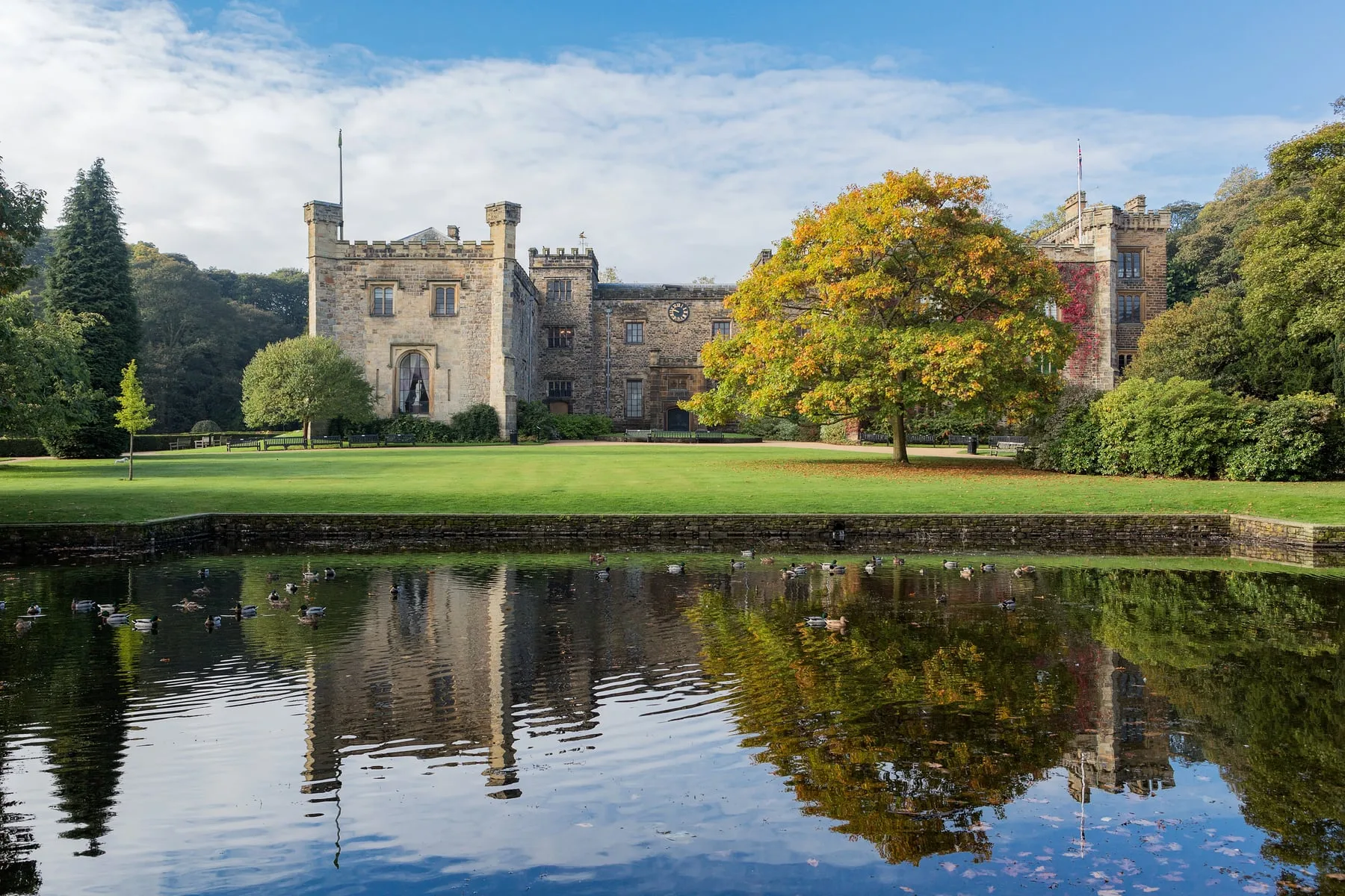 A castellated hall mirrored in its duck pond, Sizergh — Santander