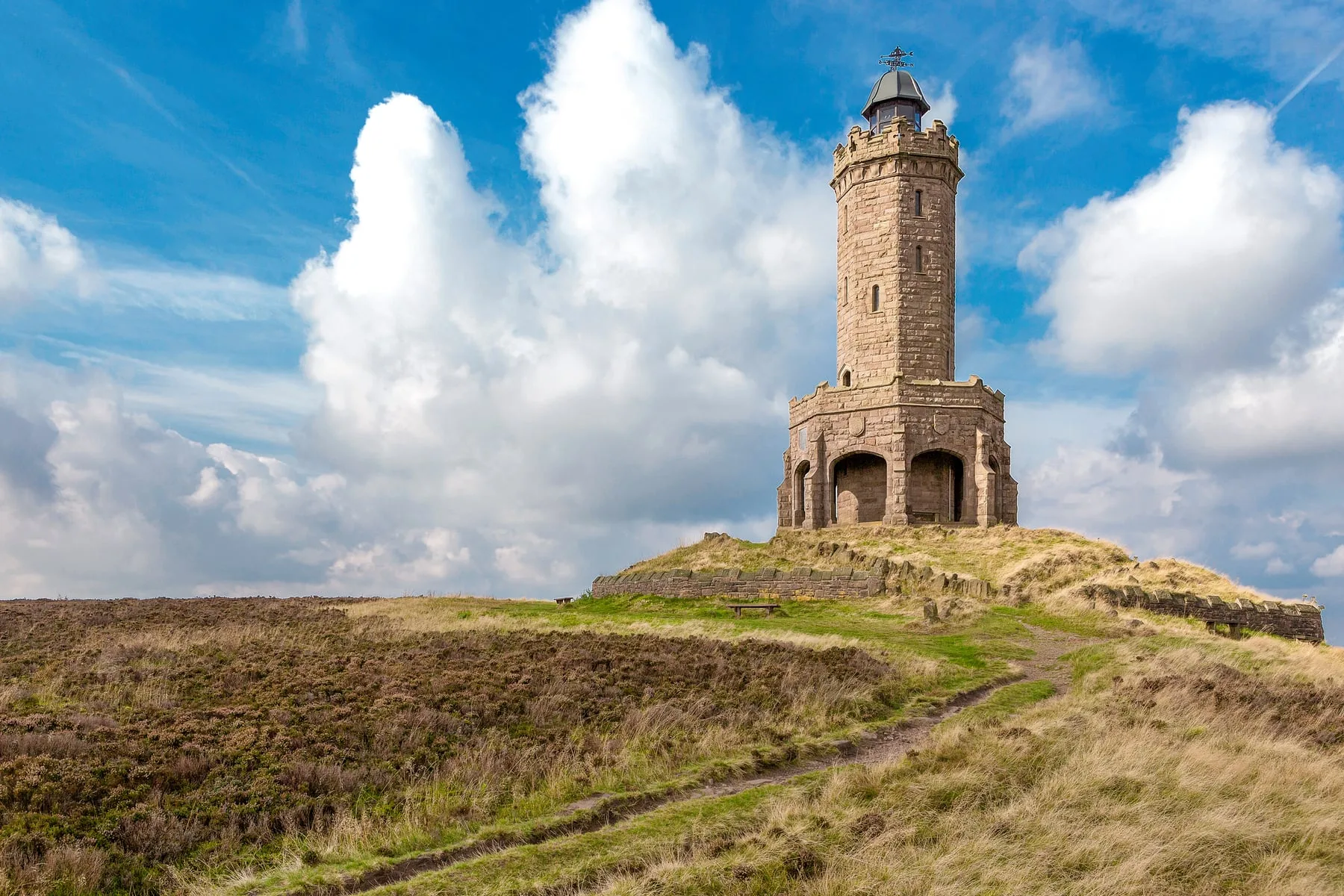 A battlemented stone tower on a heather hilltop, Langness — Santander