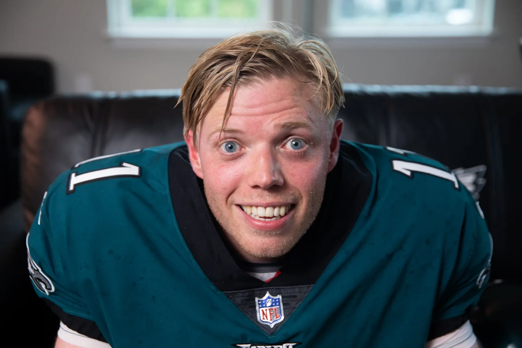Comedian Rob Beckett grinning in a Philadelphia Eagles jersey — Sky's 'Rob & Romesh Vs'