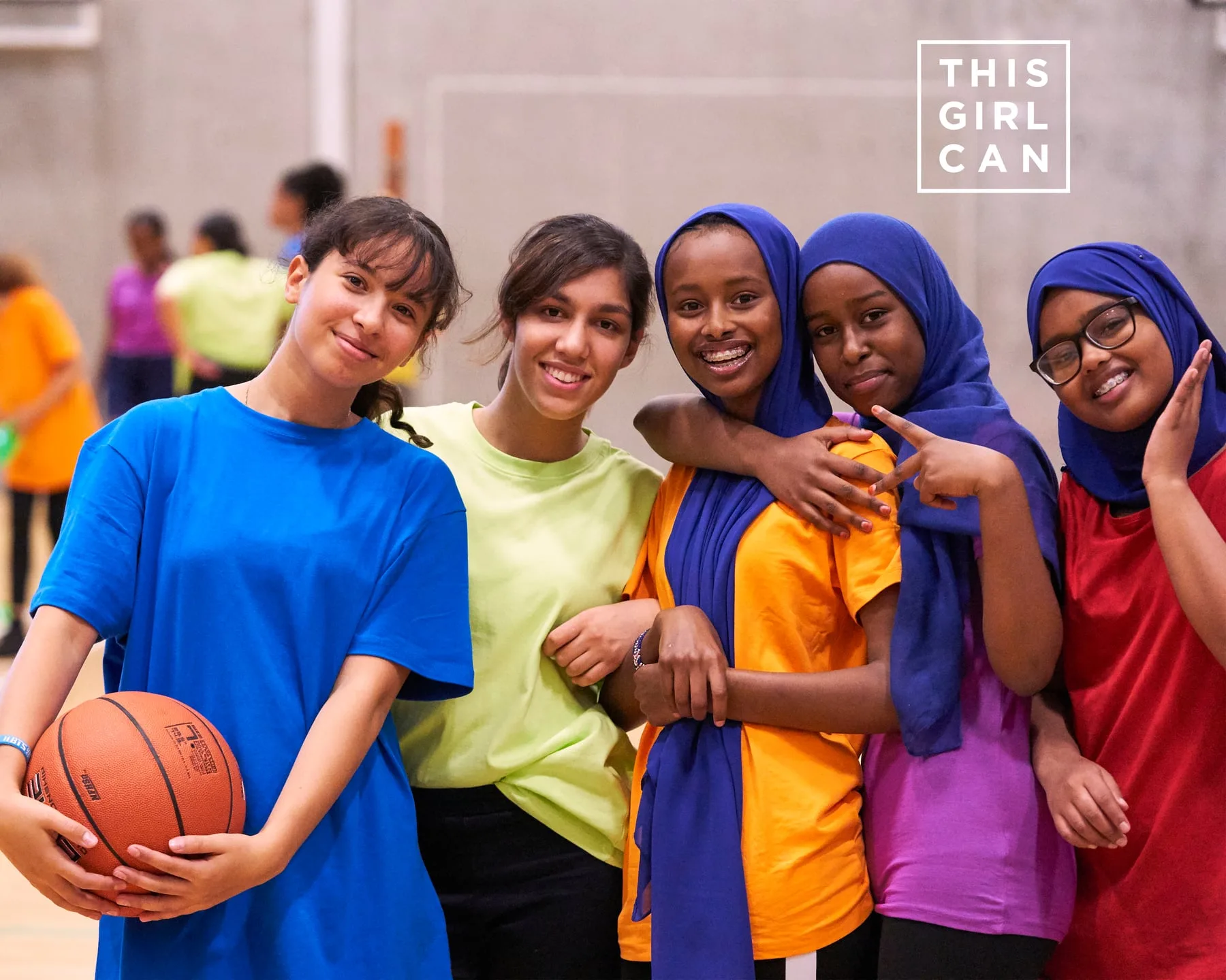 Five teenage girls with a basketball in a sports hall, This Girl Can