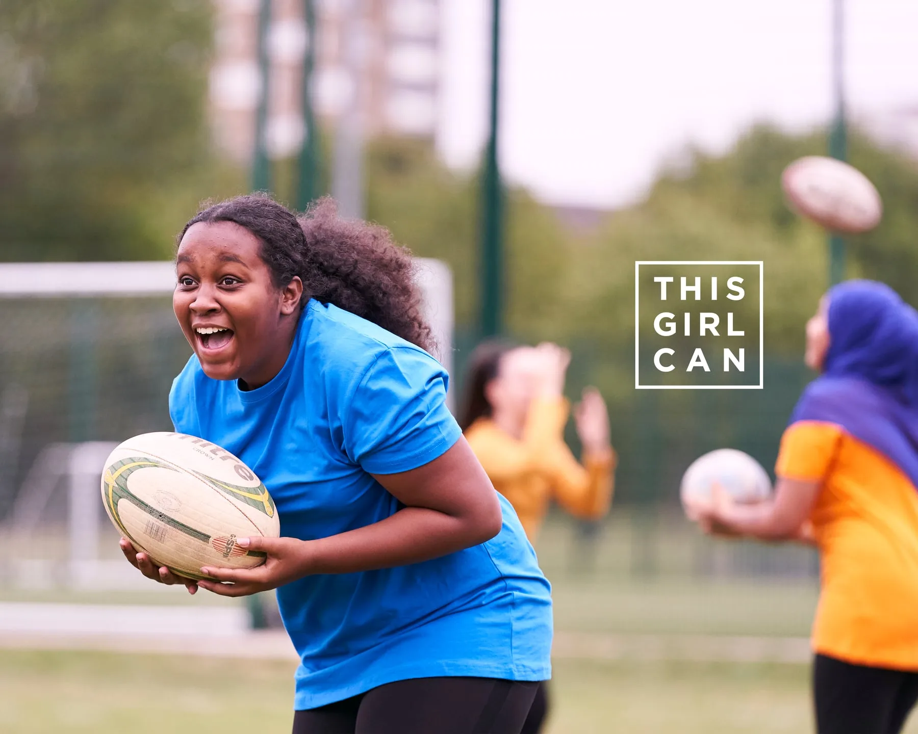 A young woman running with a rugby ball, This Girl Can