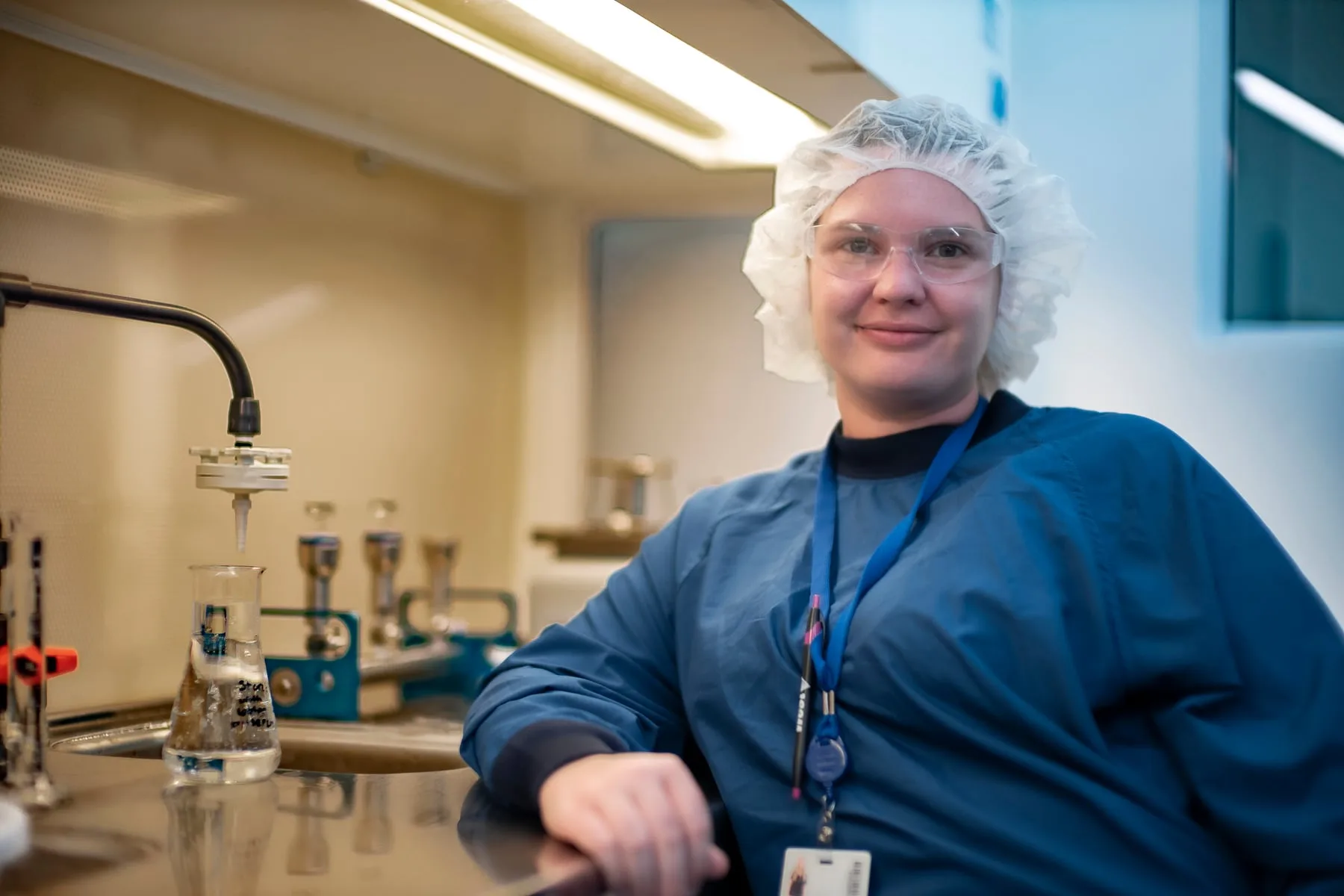 A West Pharmaceuticals lab technician at the bench with a sample flask in Raleigh, North Carolina